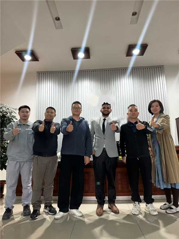 Group photo with a visiting buyer in a factory reception hall